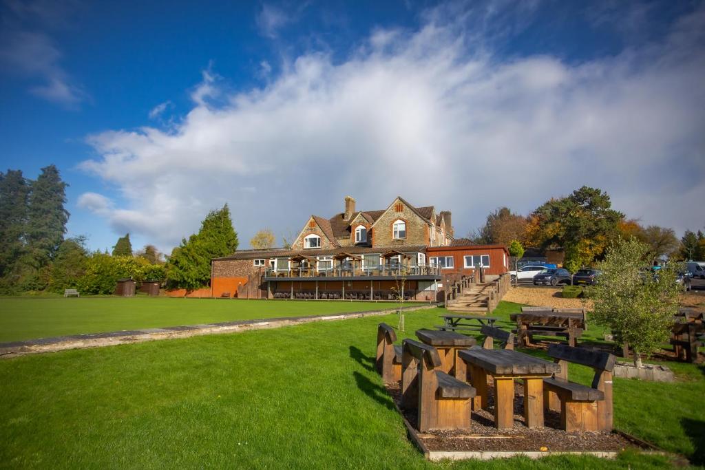 a large house with a picnic table in the grass at Bells Hotel in Coleford