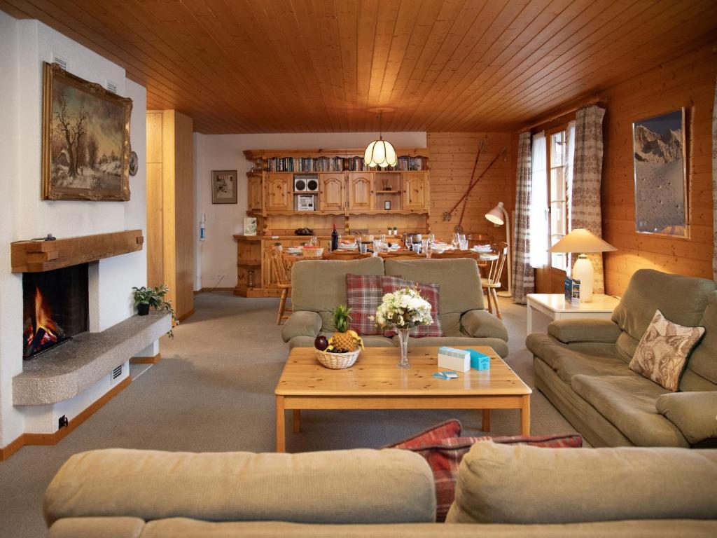 a living room with a couch and a table at Apartment Chäs Gruebi Apt-S by Interhome in Wengen
