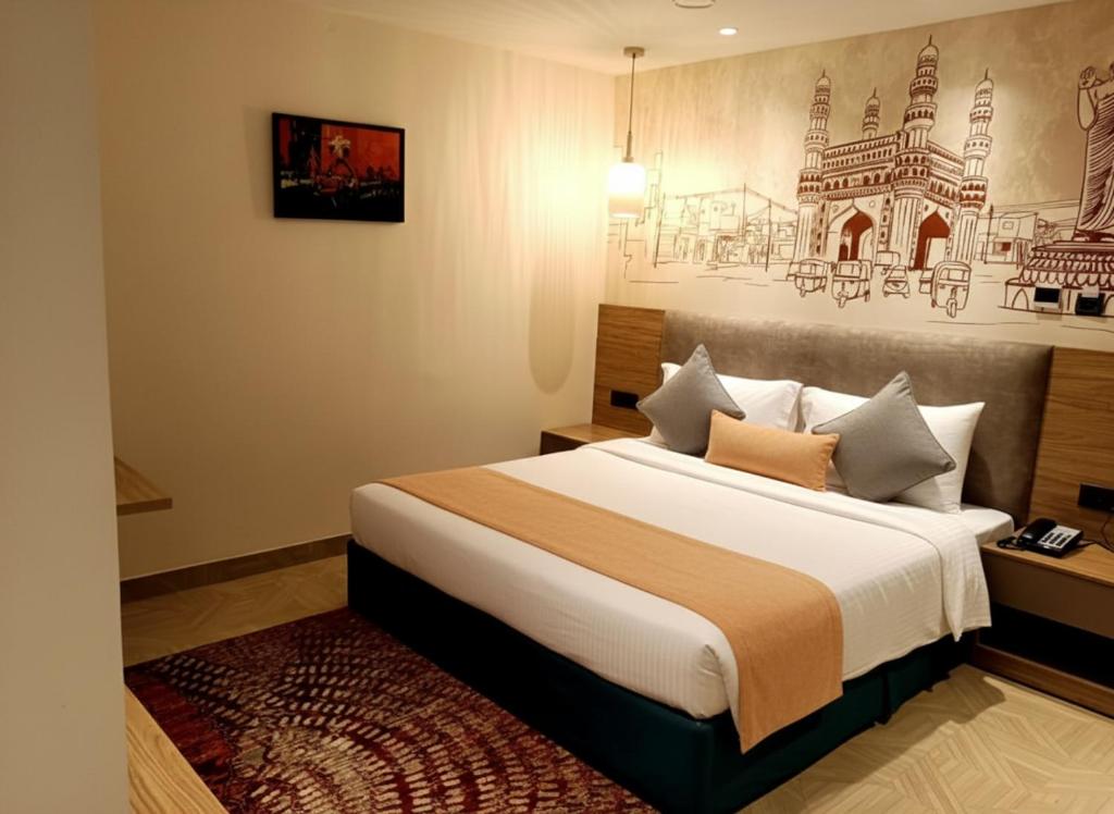 a bedroom with a large bed in a room at Klyra Hotel in Hyderabad