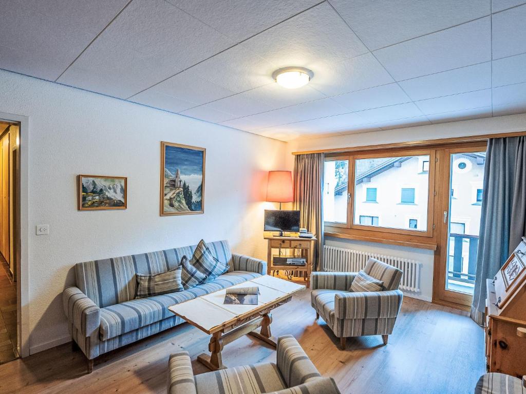 a living room with a couch and chairs and a table at Apartment Chesa Islas by Interhome in Pontresina