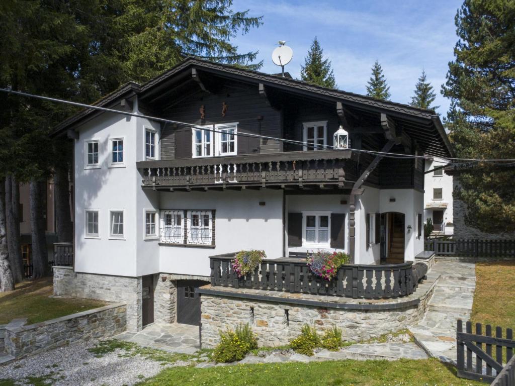 a white house with a porch and a balcony at Chalet Chalet Franca by Interhome in Madesimo