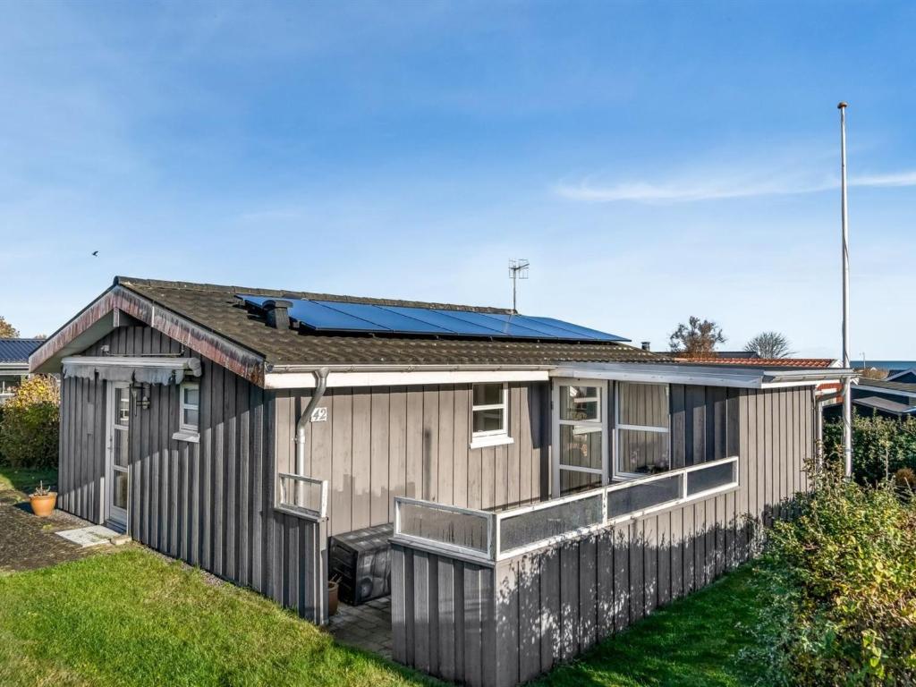 a house with a solar panel on the roof at Holiday Home Skarthi - 200m from the sea by Interhome in Sæby