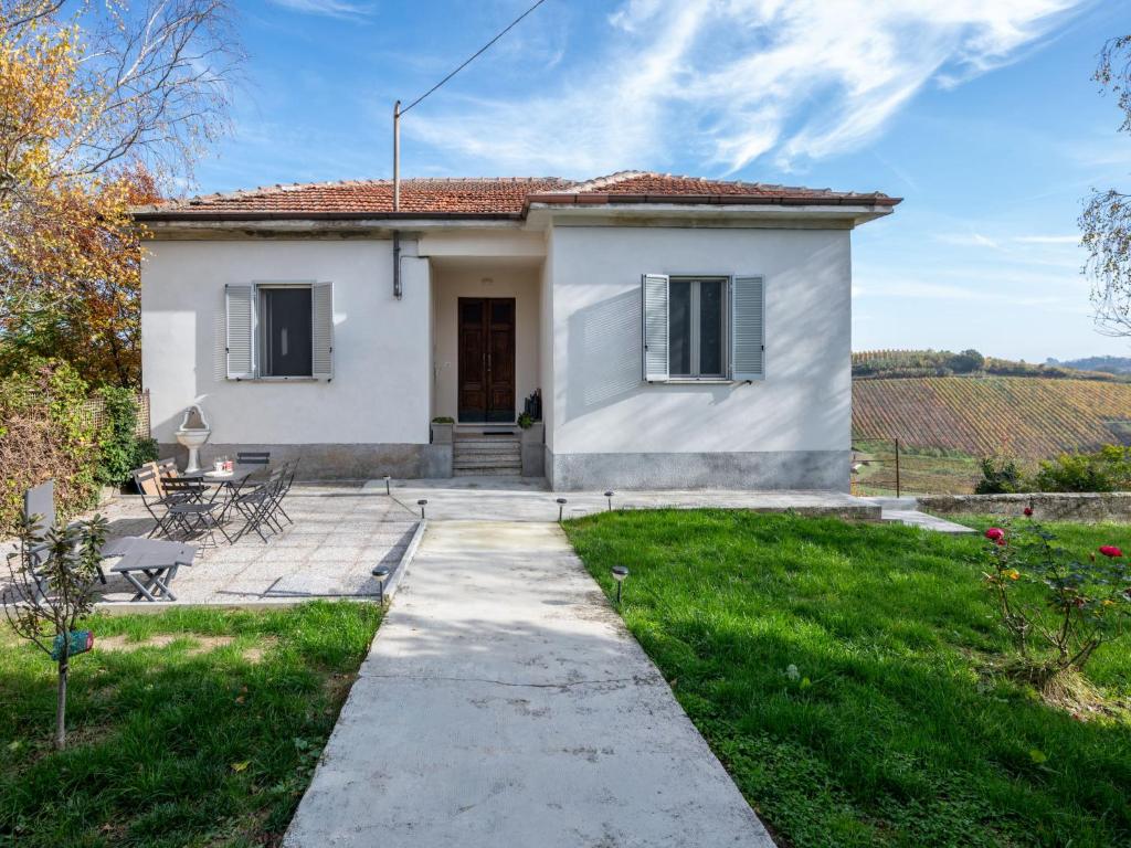 a white house with a garden and a pathway at Holiday Home Guest House Viotti by Interhome in Castel Rocchero