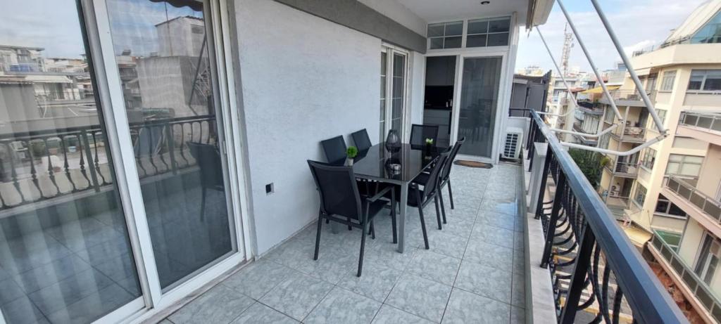 a balcony with a table and chairs on it at Faros & Beach View in Alexandroupoli