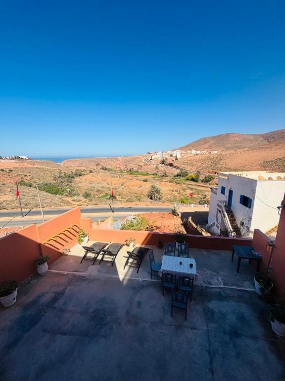 a patio with a table and chairs on a building at Sunrise Camp in Mirleft
