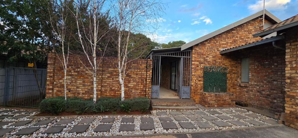 米德尔堡Middelburg Guesthouse的砖屋,有门和车道