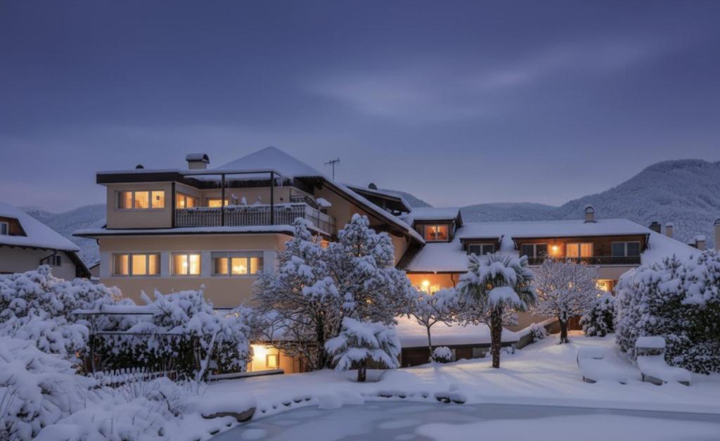 a large house in the snow at night at Kreuzwegerhof Nals - Historic Nature Stay with Pool near Meran & Bozen in Nalles