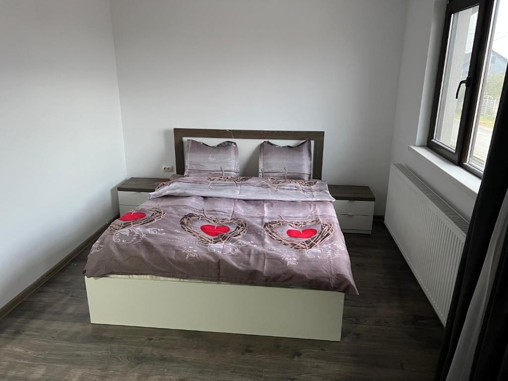a bedroom with a bed with two hearts on it at Villa59 in Preajba