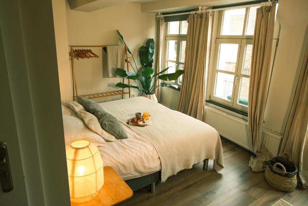 a bedroom with a bed with a plate of food on it at Milk and cookies in Venlo