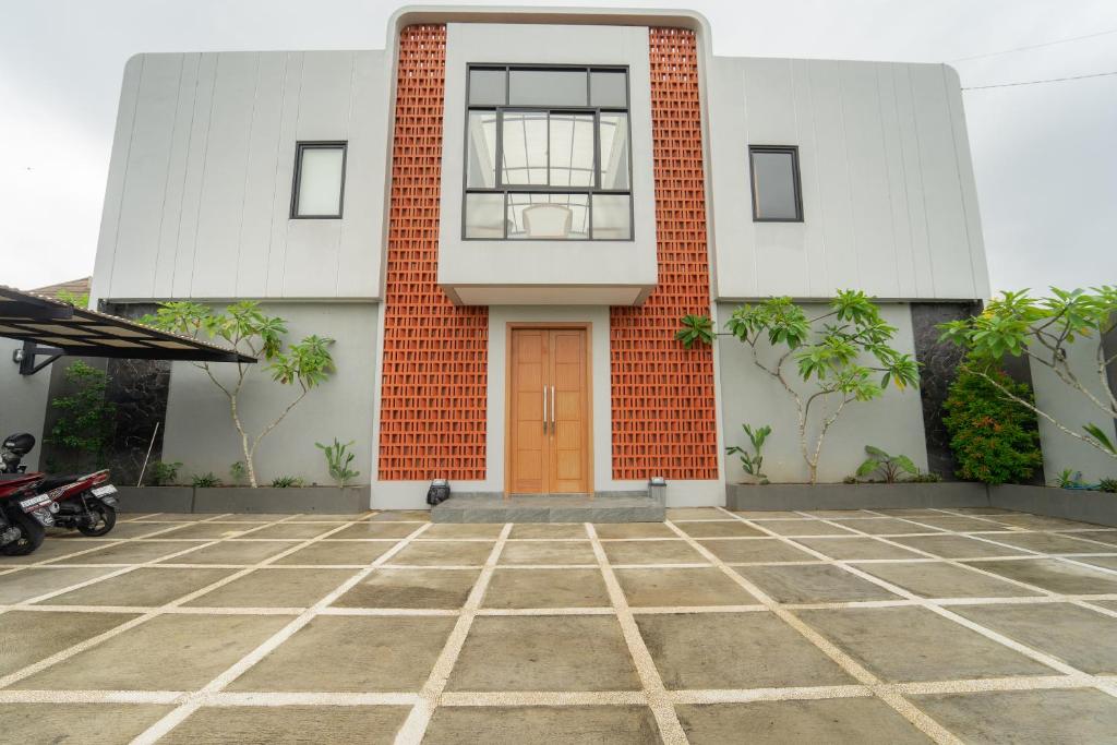 a building with a orange door in front of it at Kragilan CoLiving By ARBA in Jetis