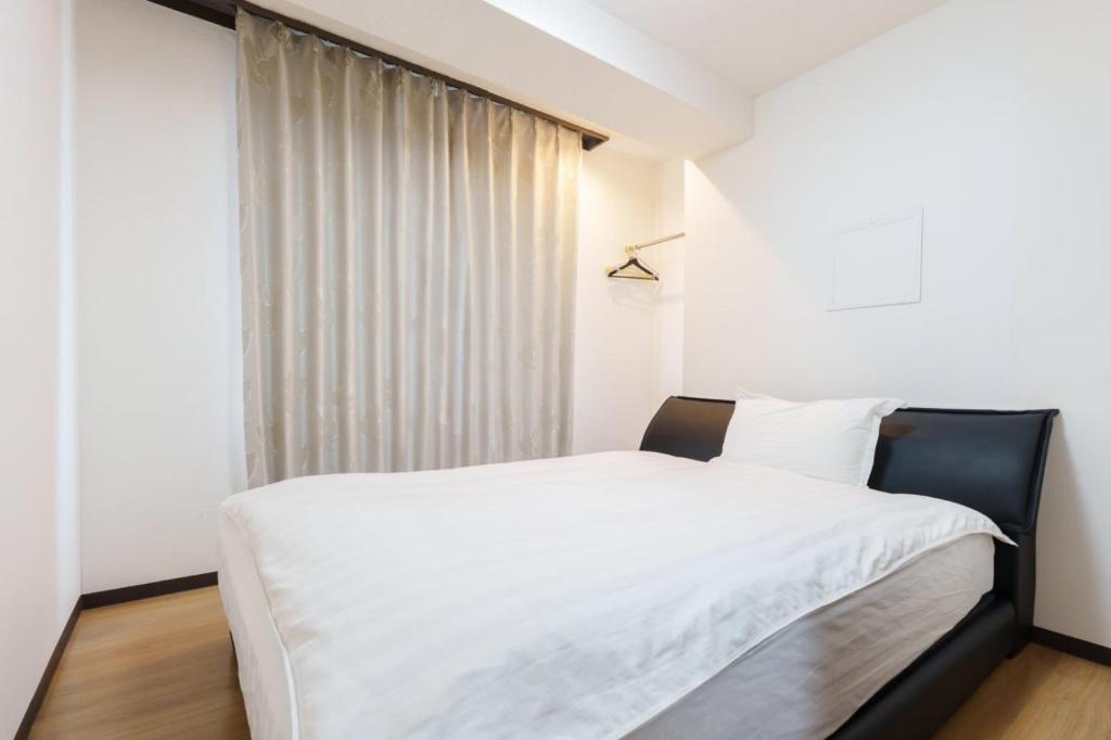 Ένα ή περισσότερα κρεβάτια σε δωμάτιο στο Nihonbashi Minshuku 義の居