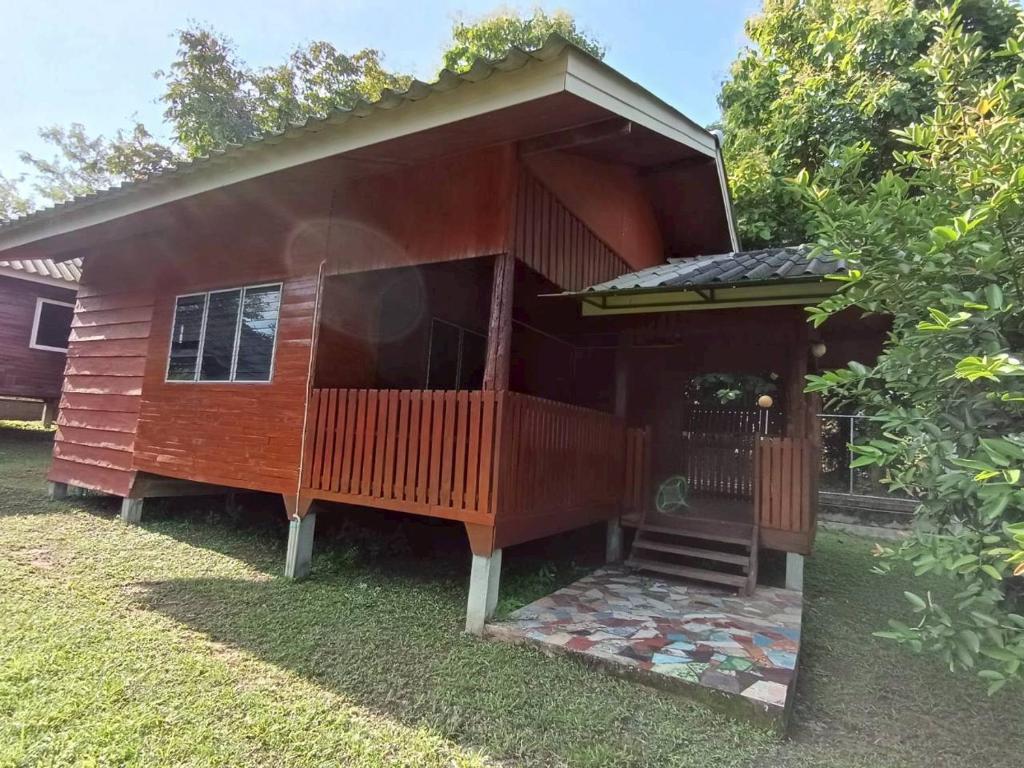 a small house with a porch and a deck at Doisaket hills in Doi Saket