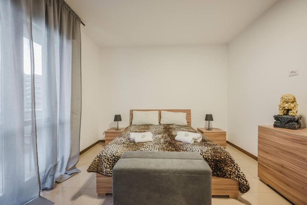 a bedroom with a leopard print bed and a chair at 2 camere, parcheggio gratis, 10 minuti da Venezia in Venice