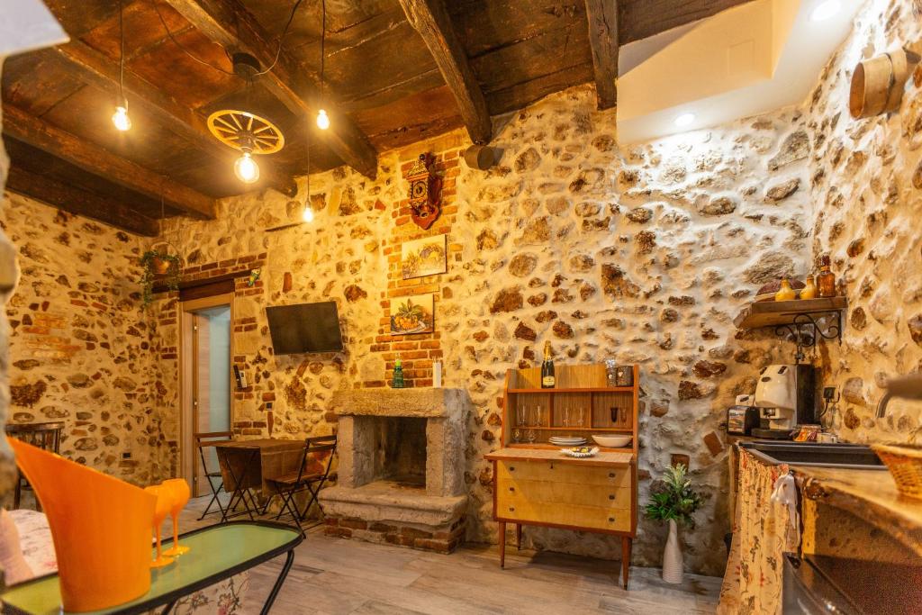 a kitchen with a stone wall with a fireplace at Casicarillo 800 in Serino