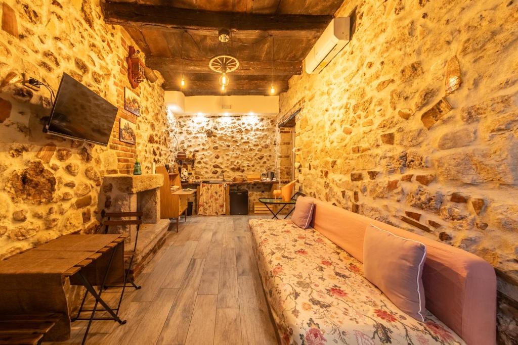 a room with a stone wall with a couch in it at Casicarillo 800 in Serino