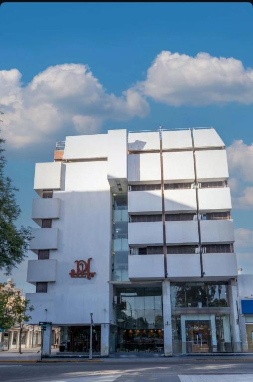 a white building with a sign on the side of it at Plaza Hotel in La Rioja