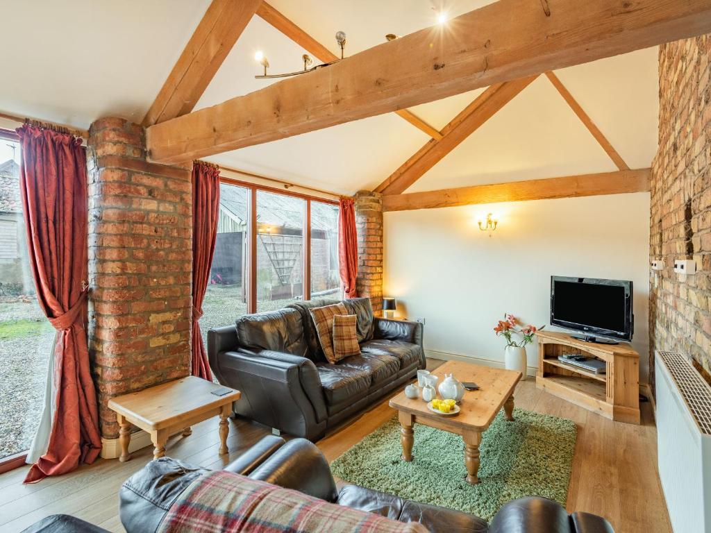 a living room with a couch and a tv at The Tack Rooms - Uk37520 in Routh