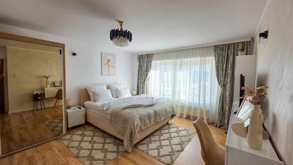 a bedroom with a bed and a large window at Central Modern View AP in Râmnicu Vâlcea