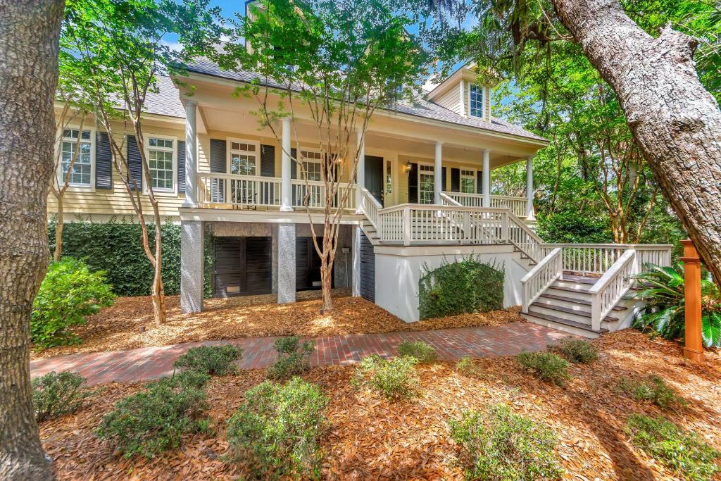 a large house with a porch and trees at MH3012: 3012 Marsh Haven in Seabrook Island