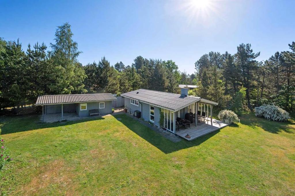 a home with a large yard with a house at Well-Designed House In Scenic Surroundings in Martofte
