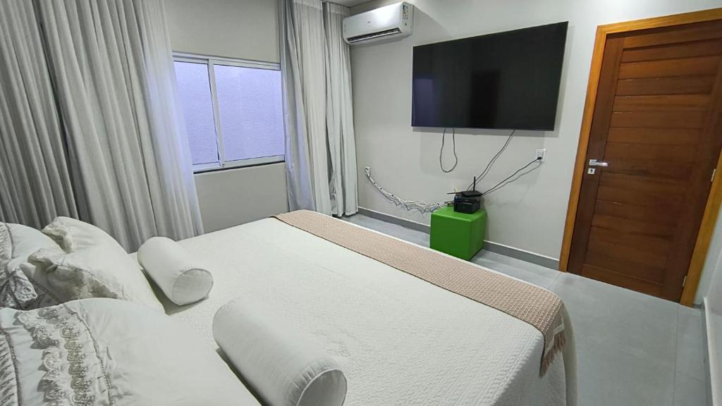 En eller flere senge i et værelse på Casa Conforto