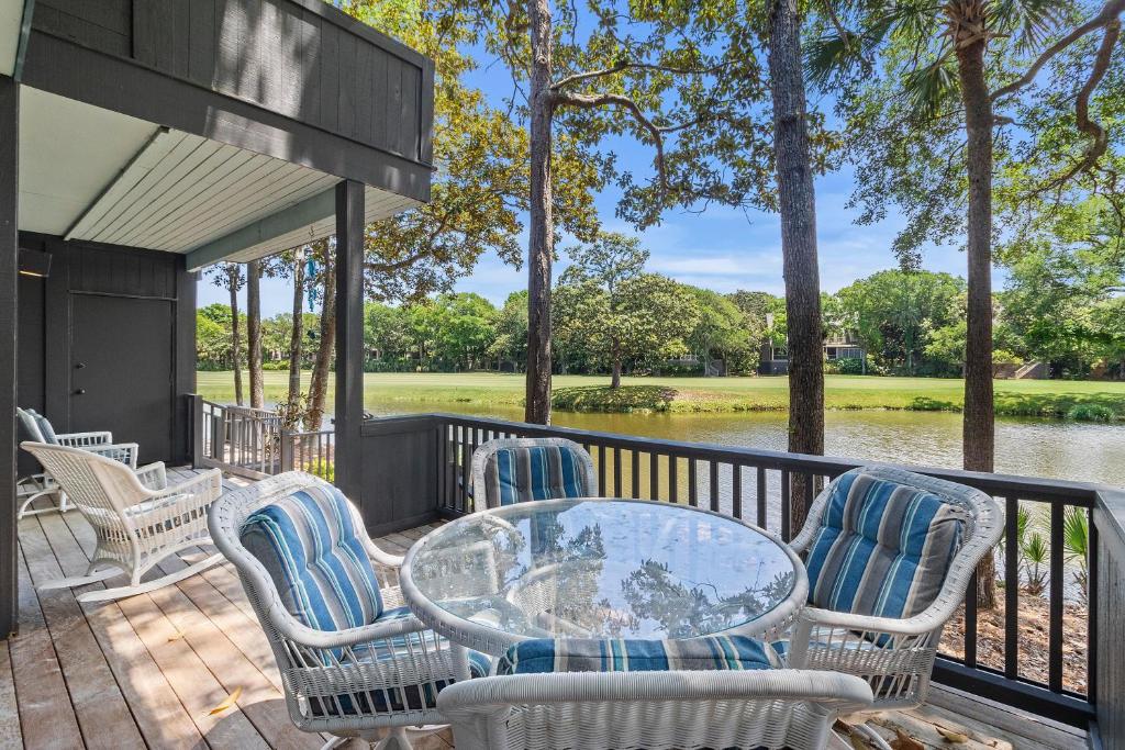 a patio with chairs and a glass table on a deck at TP4937: 4937 Turtle Point in Kiawah Island