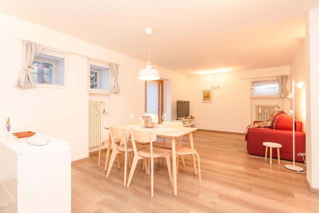 a kitchen and dining room with a table and chairs at La Casa di Paola in La Thuile