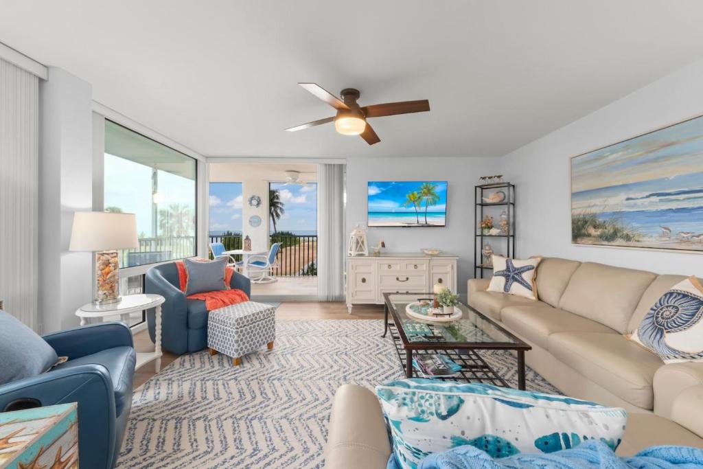 a living room with a couch and a ceiling fan at Island Beach Club 210E in Sanibel