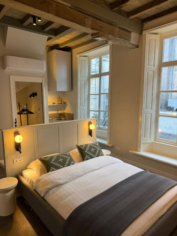 a bedroom with a large bed with two pillows at Boutique hotel the Grand in Nijmegen