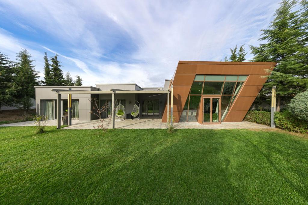 a house with a green lawn in front of it at 9 April Village Sea & Spa Varna in Varna City