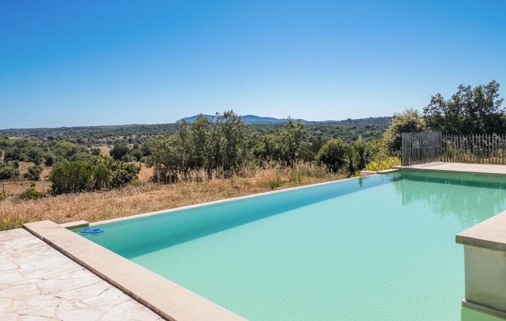 a swimming pool with a view of the hills at Gorgeous Home In Lussan in Fons-sur-Lussan