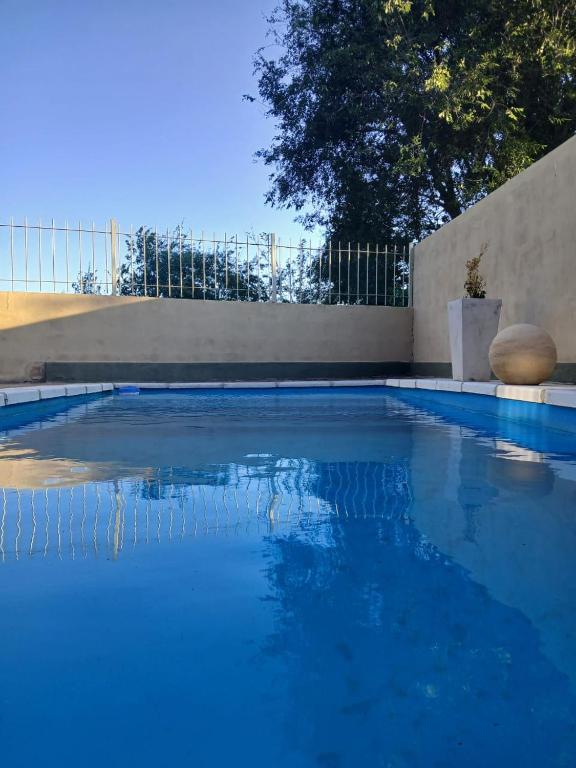 a large swimming pool with blue water at PUEBLO MIO in Cosquín