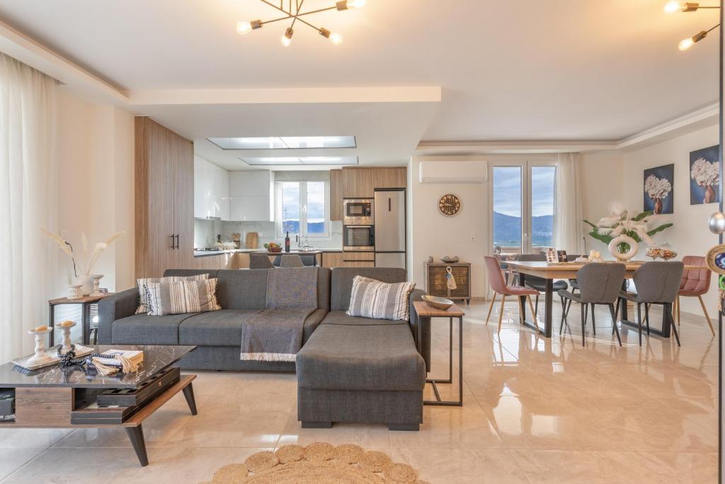 a living room with a couch and a table at Athena Home South Crete in Kapparianá