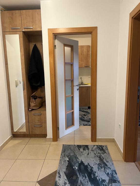 a room with a door open to a kitchen at Bulevar in Sarajevo