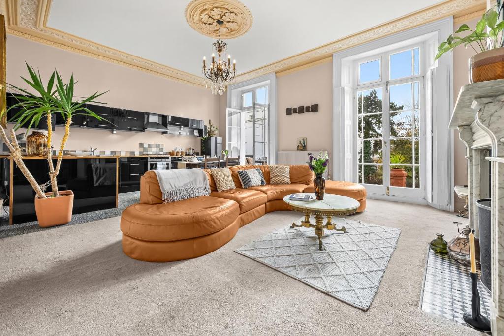 a living room with a couch and a table at Spacious Apartment with Balcony, Clarendon Square in Leamington Spa