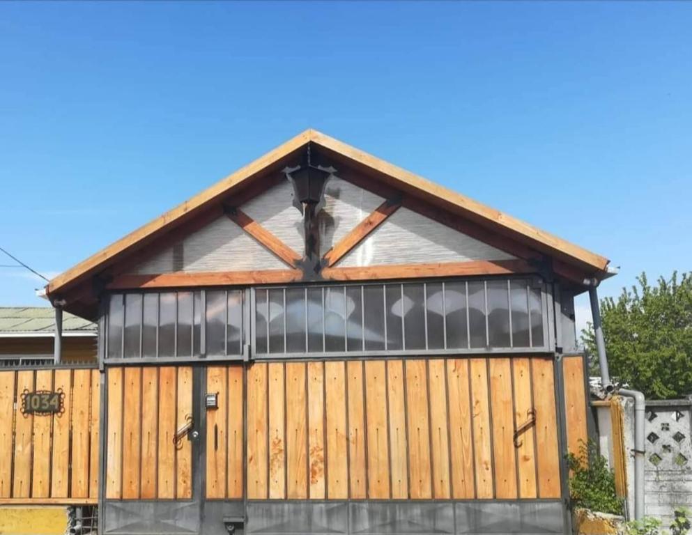 a large wooden building with a gambrel roof at Hospedaje con Pensión Completa in Angol