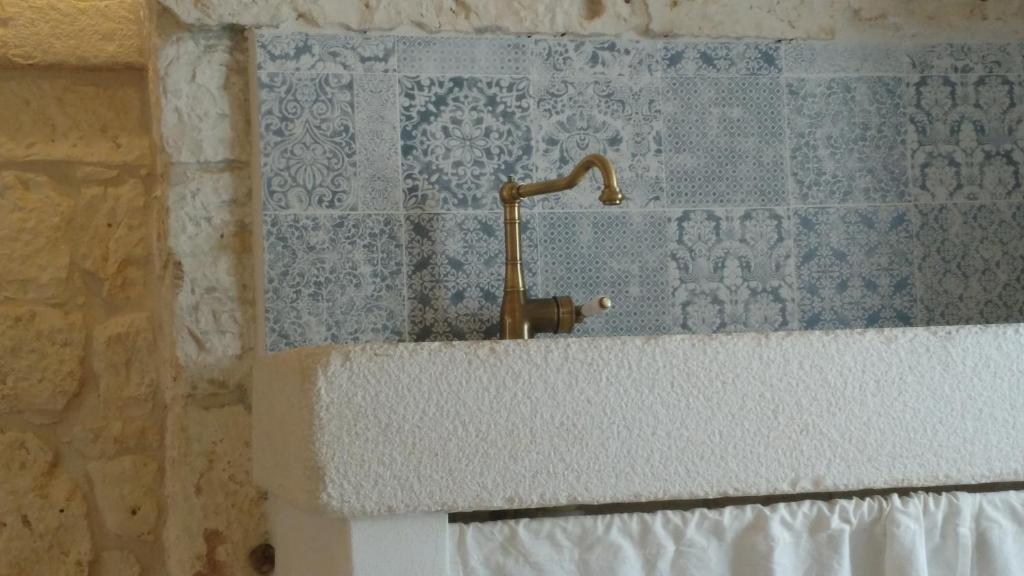 a sink with a faucet in a bathroom at Dimora Sumerano in Alberobello