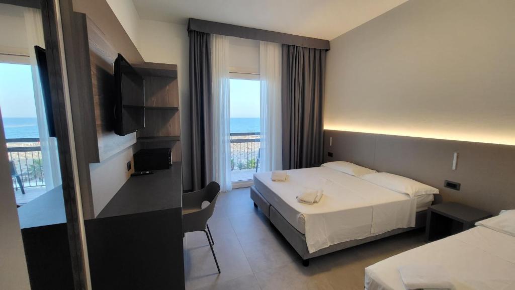 a hotel room with a bed and a view of the ocean at Hotel Seaview in Rimini