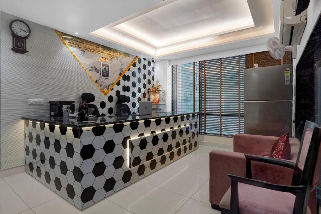 a kitchen with a black and white checkered counter at Hotel O elvilla in New Delhi