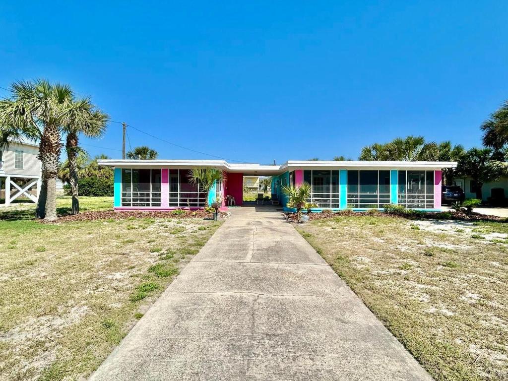 a house with a pathway in front of it at Baked and Barefoot Beach Bunglows in St. George Island