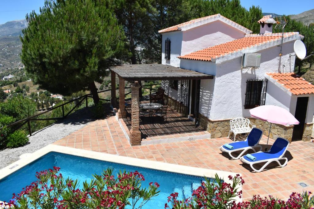 a villa with a swimming pool and a house at Finca La Jara with private Pool in Cómpeta