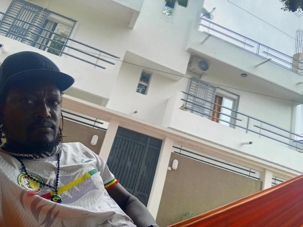 a man standing in front of a house at Villa keur Baye fall in Sali Nianiaral