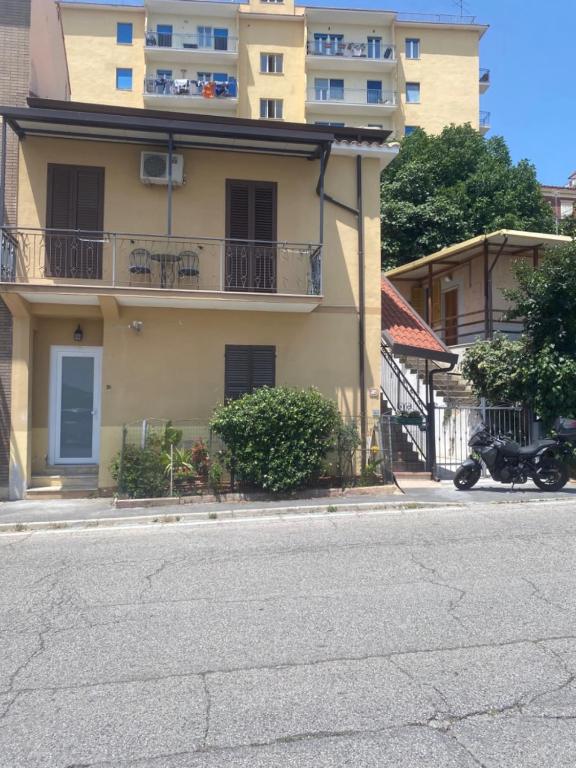 a building with a motorcycle parked on the side of the street at B&B La Fenice in Chieti