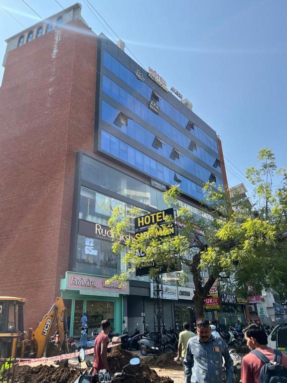 a building with a hotel sign in front of it at Hotel Shyam Inn in Vadodara