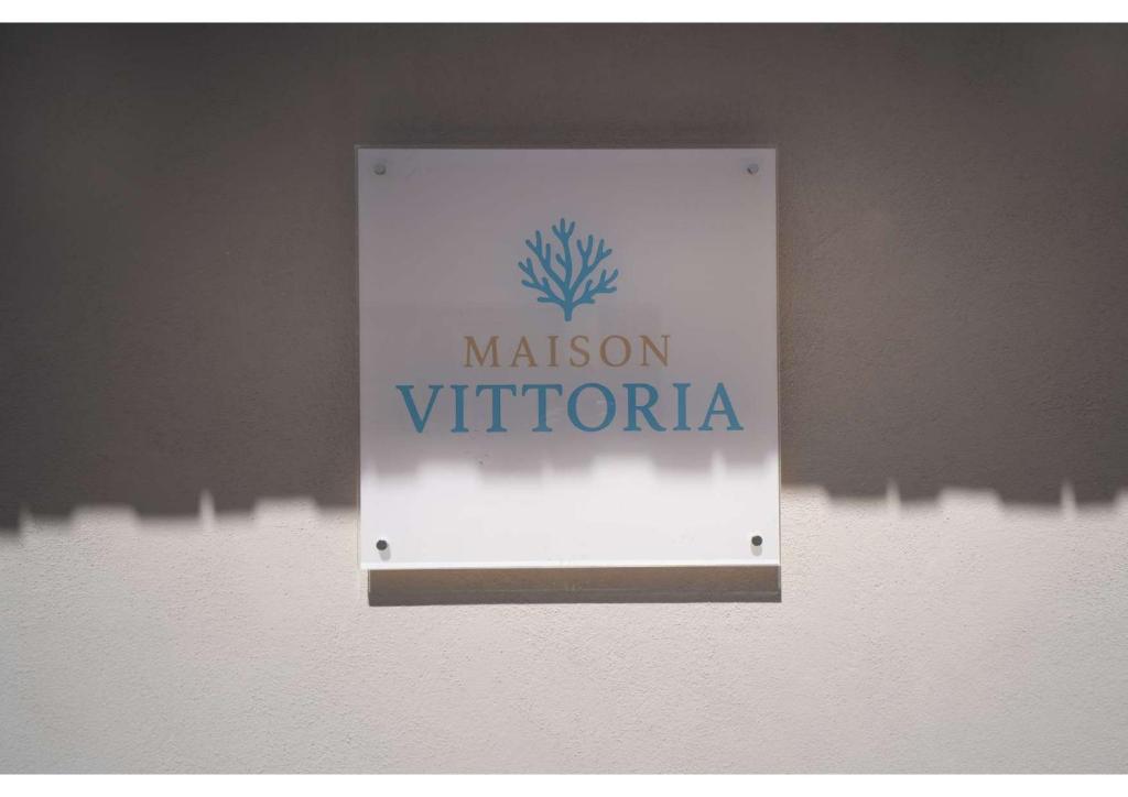 a sign on a wall that says mission vittoria at Maison Vittoria in Ischia Town