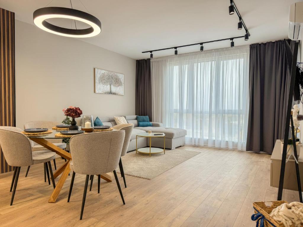 a living room with a table and a couch at 2BР Apartment in a Modern Complex in Plovdiv