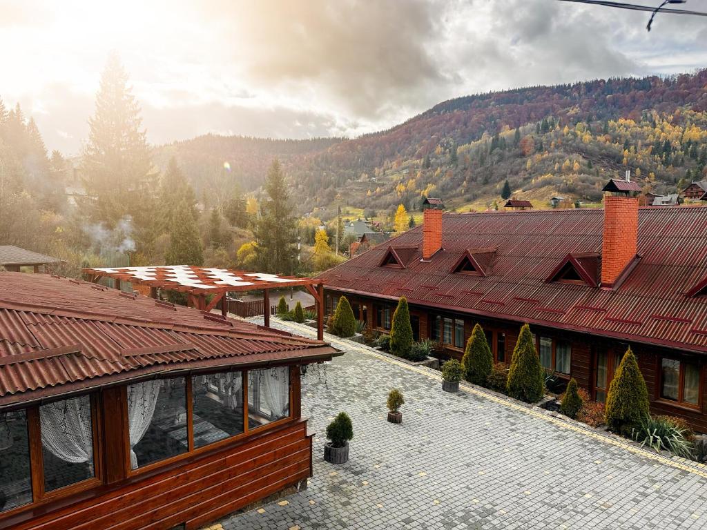 a view of a building with mountains in the background at Chalet Filvarok in Slavske
