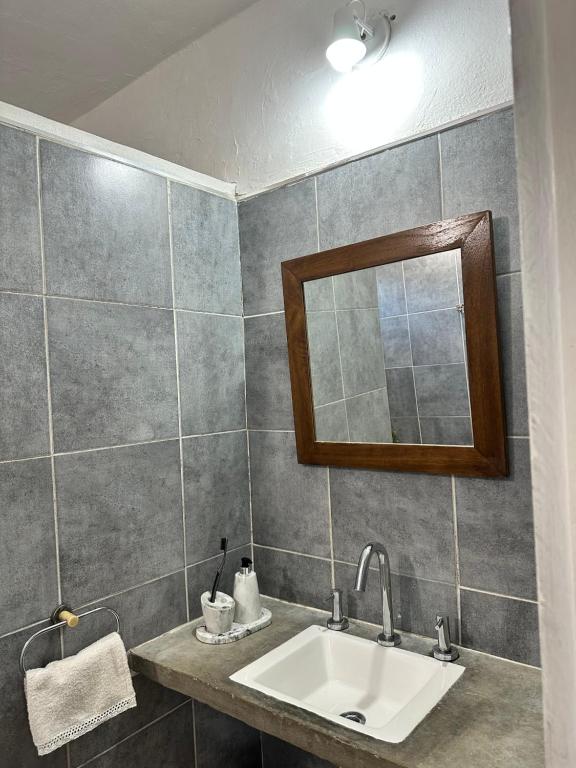 a bathroom with a sink and a mirror at La Colorada de Yacanto in Villa Yacanto