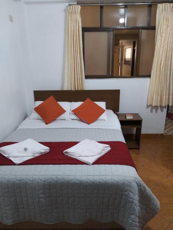 Ένα ή περισσότερα κρεβάτια σε δωμάτιο στο Hospedaje Tres Cruces