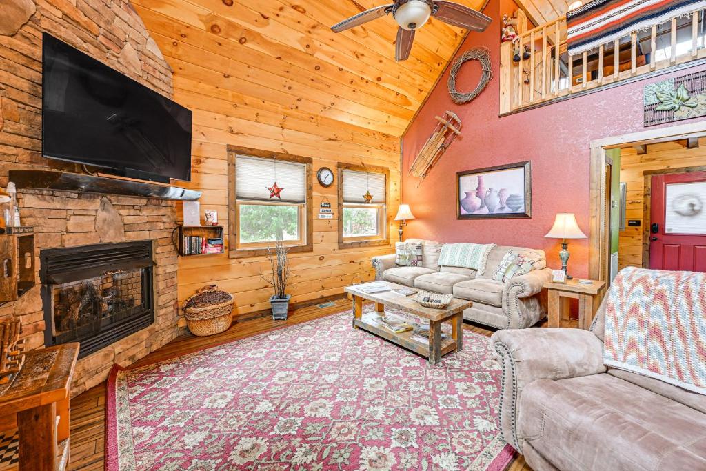 a living room with a fireplace and a tv at Cozy Couples Getaway with Hot Tub Fox Ridge Cabin in Whittier